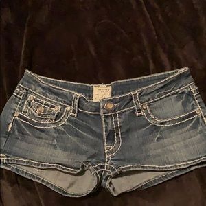 L.A. Idol jean shorts with white stitching.